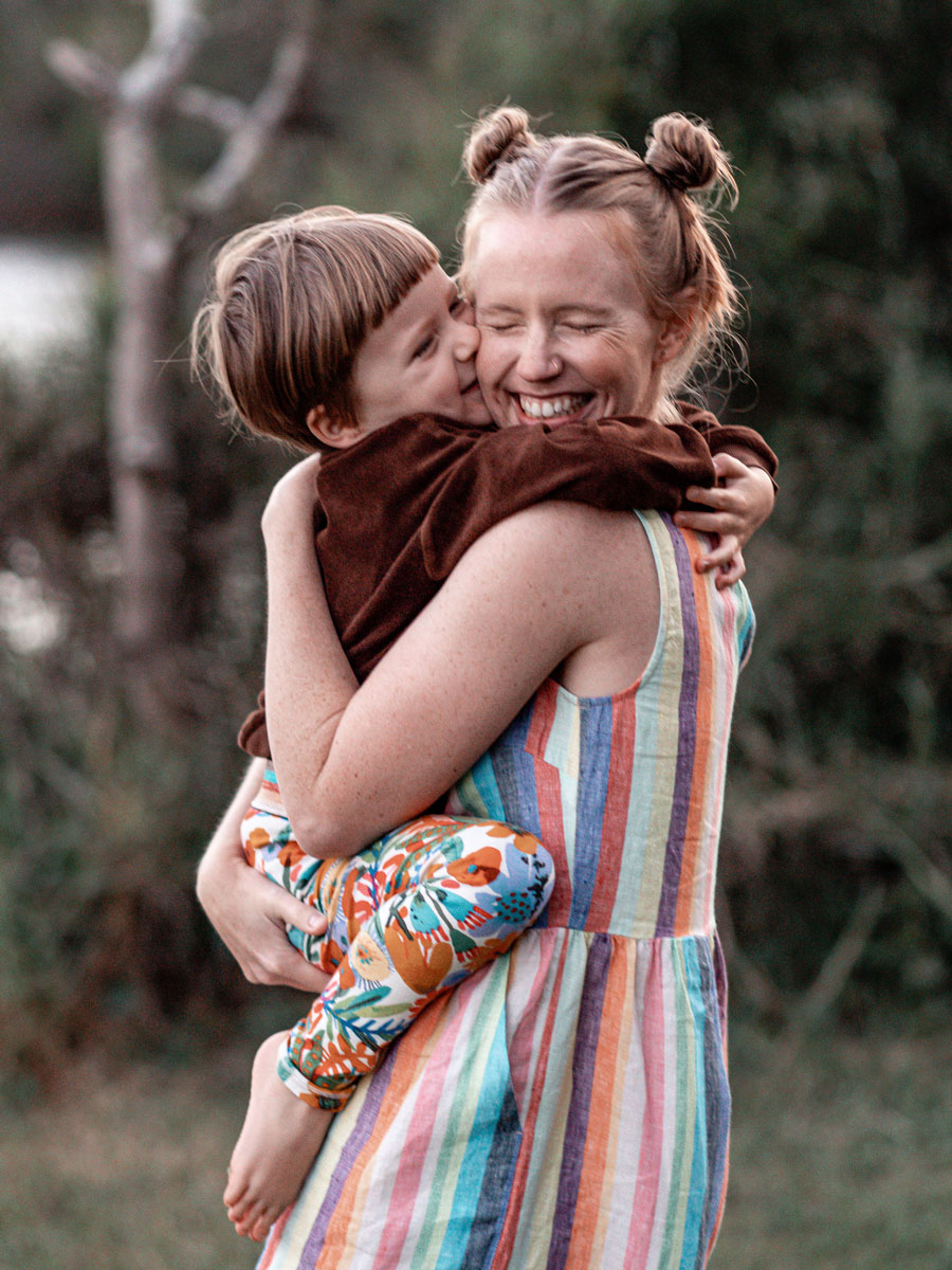 Dani Hunt, Founder of Neverland Studio, receiving a big hug from her son